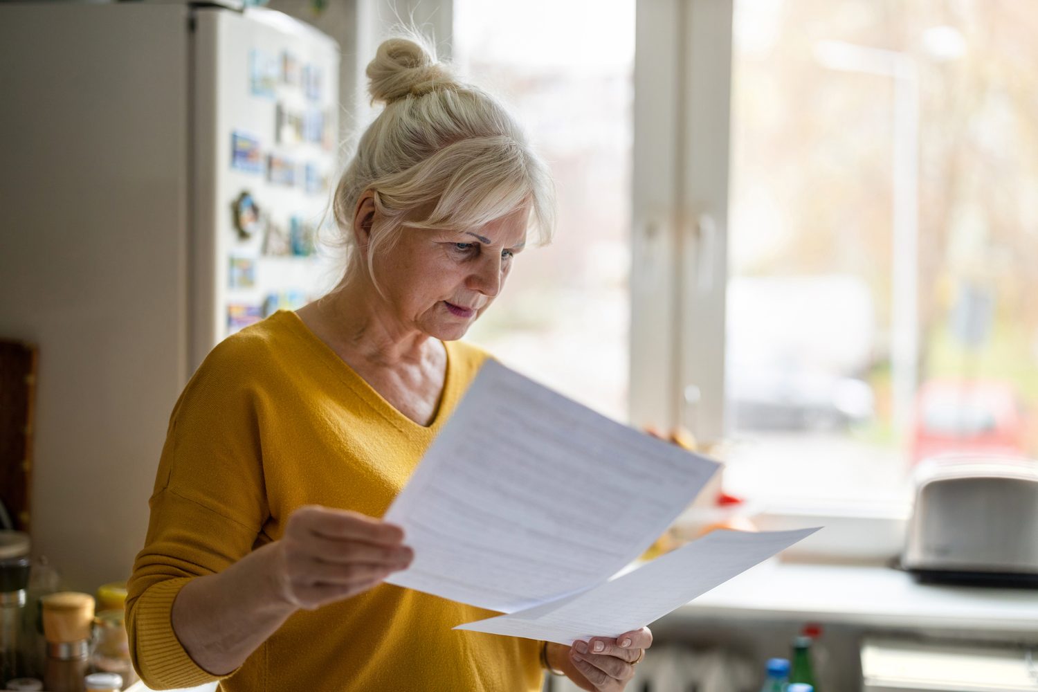 Photo — reading an unexpected medical bill at home