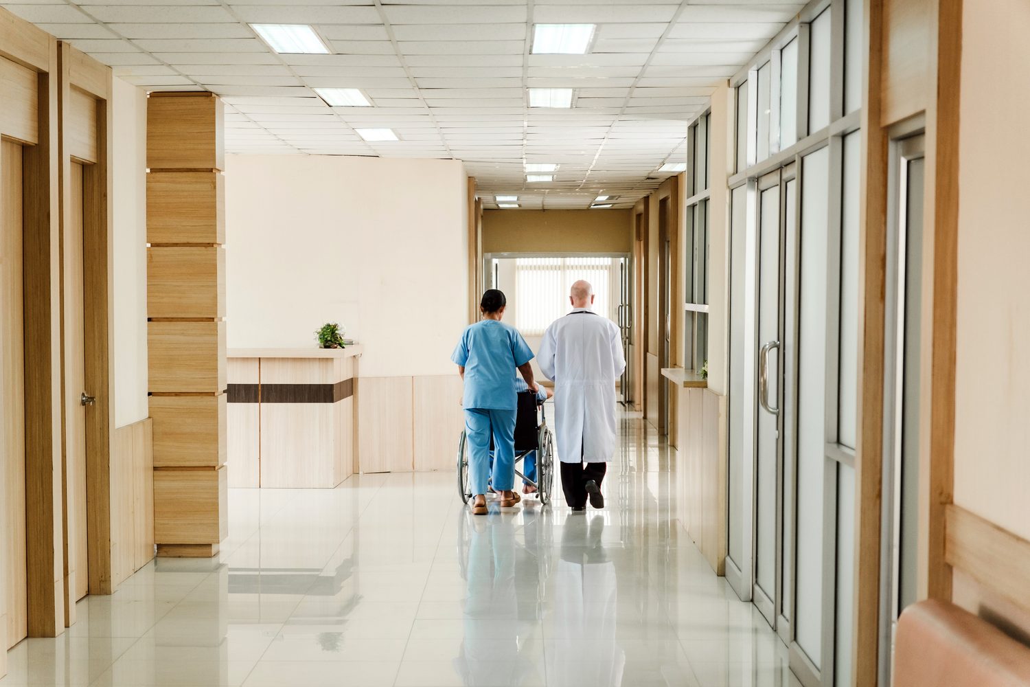 Medical staff and a patient in a hospital corridor